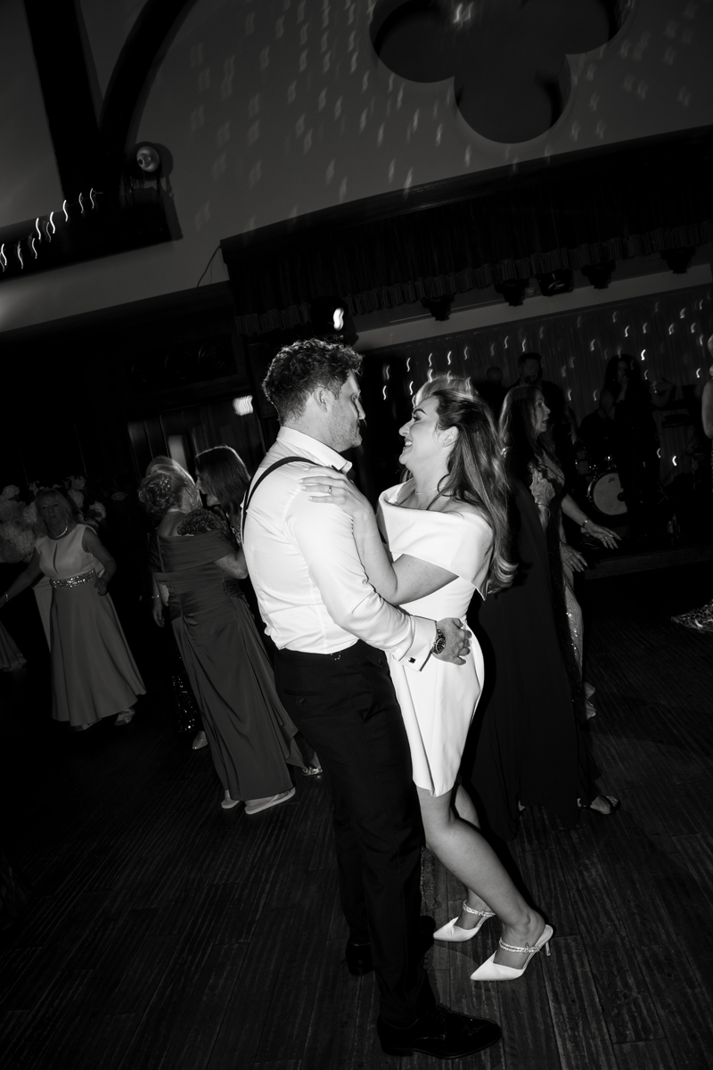 Bride and groom dancing together during their evening wedding reception at Crossbasket Castle.