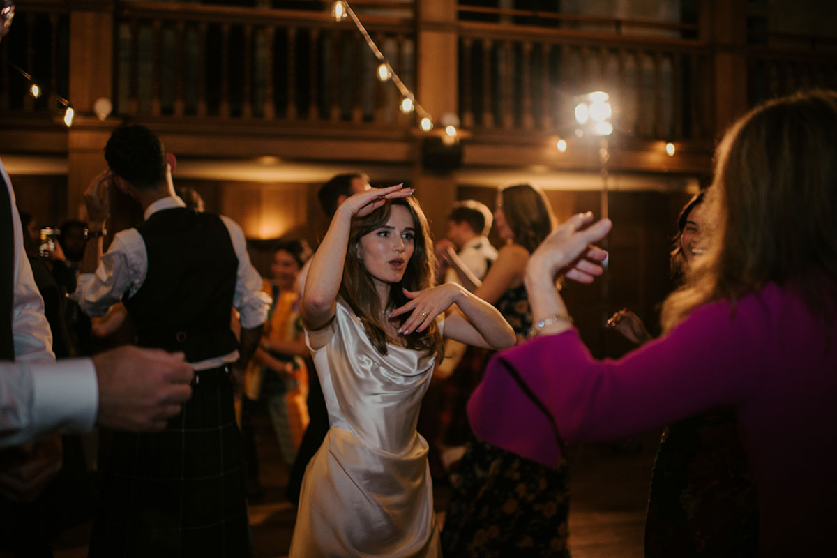 a bride and wedding guests dancing in the ballroom at Achnagairn Castle