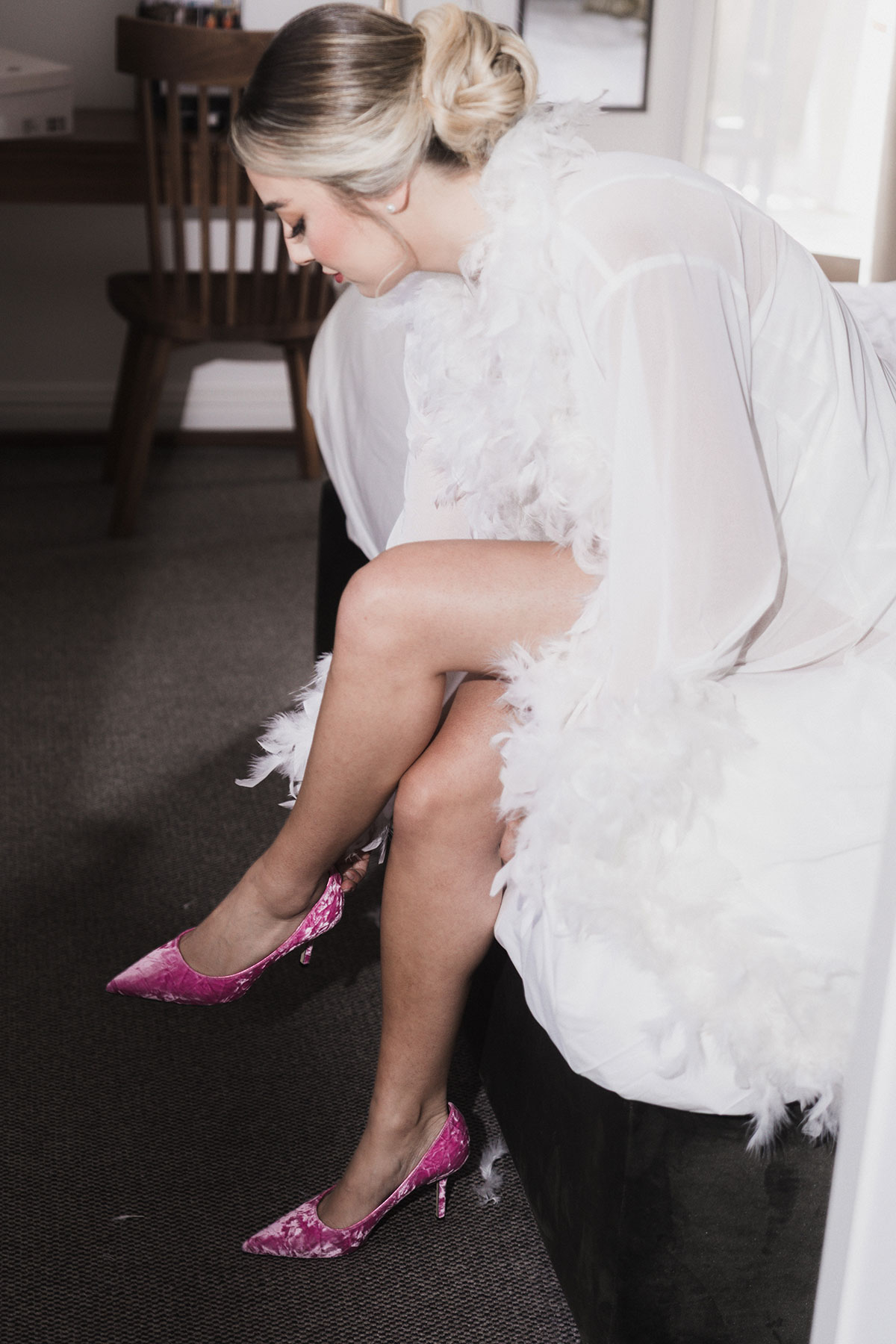 Close-up of bride’s pink velvet heels during Mansfield Traquair wedding preparations