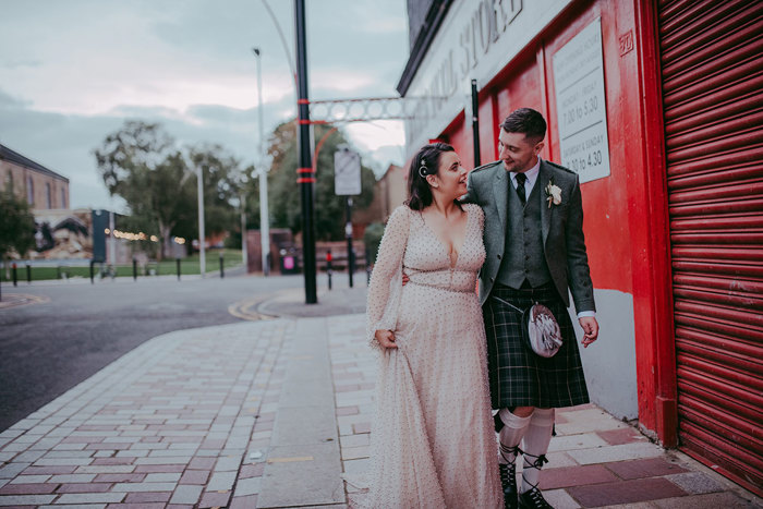 Bride And Groom Walking Along Street At Barras In Glasgow By Pocket Square Photography
