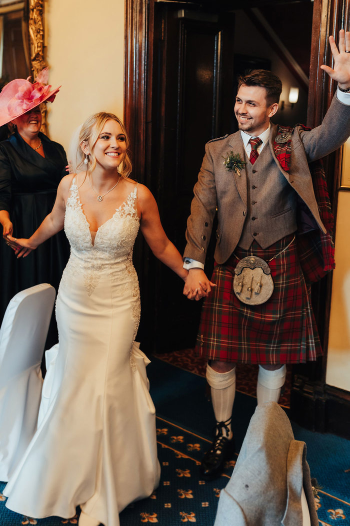 bride and groom cheering on their wedding day at dalhousie castle