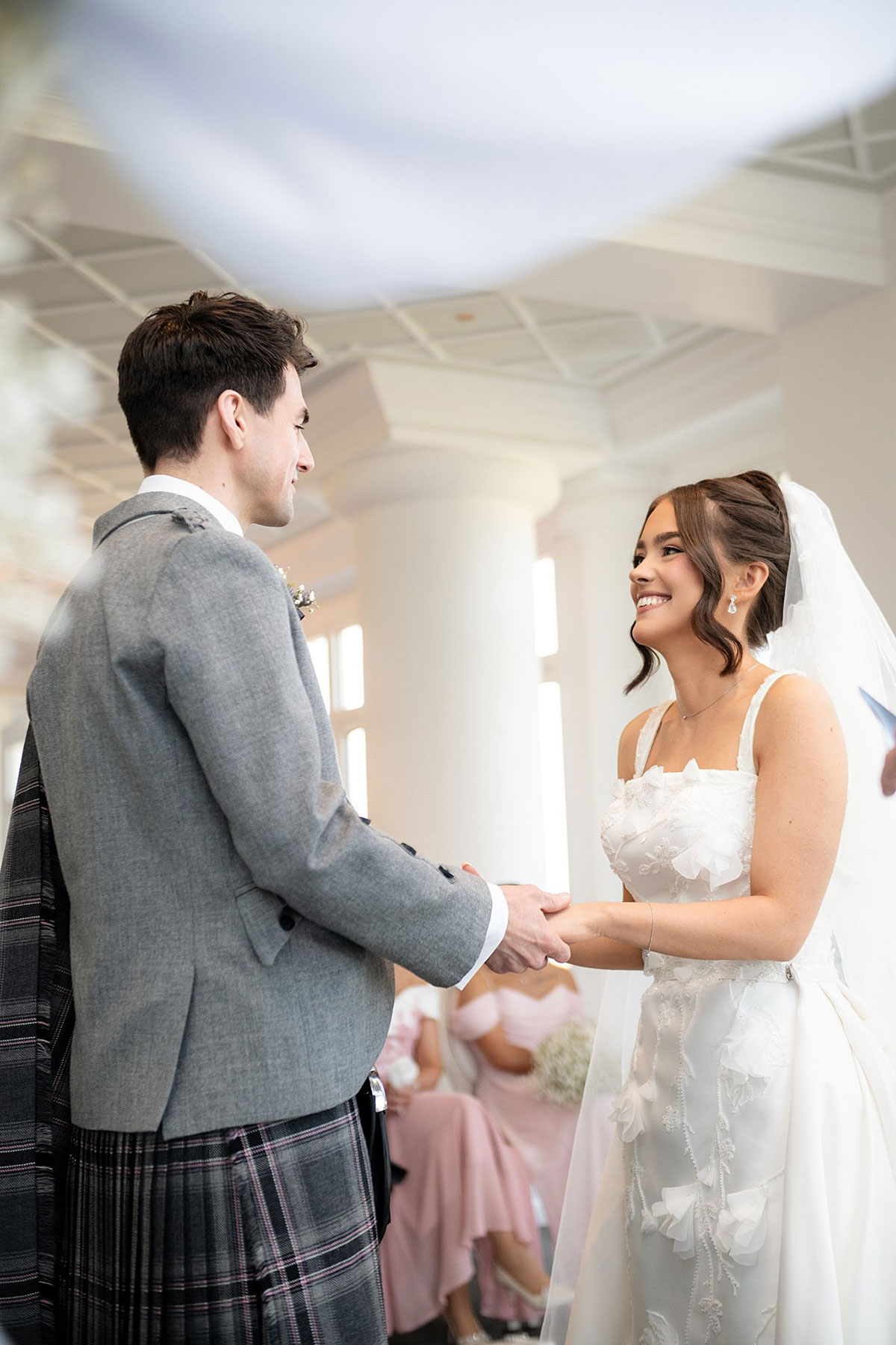 Bride and groom exchanging vows during humanist wedding ceremony at Old Course Hotel conservatory in St Andrews.