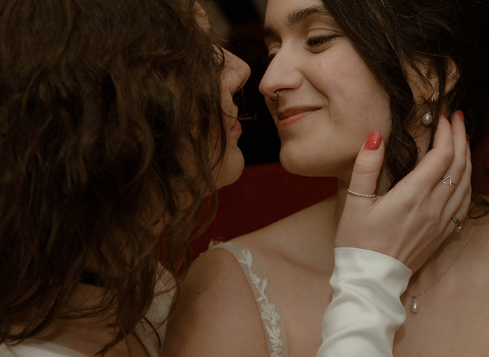 a close up of the faces of two brides about to kiss