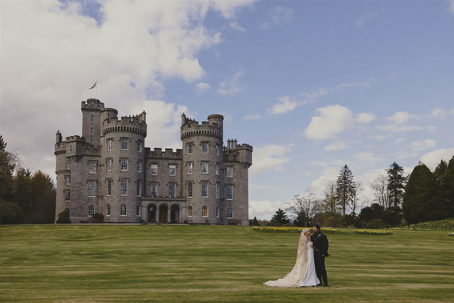  A bride and groom in front of Cluny Castle.