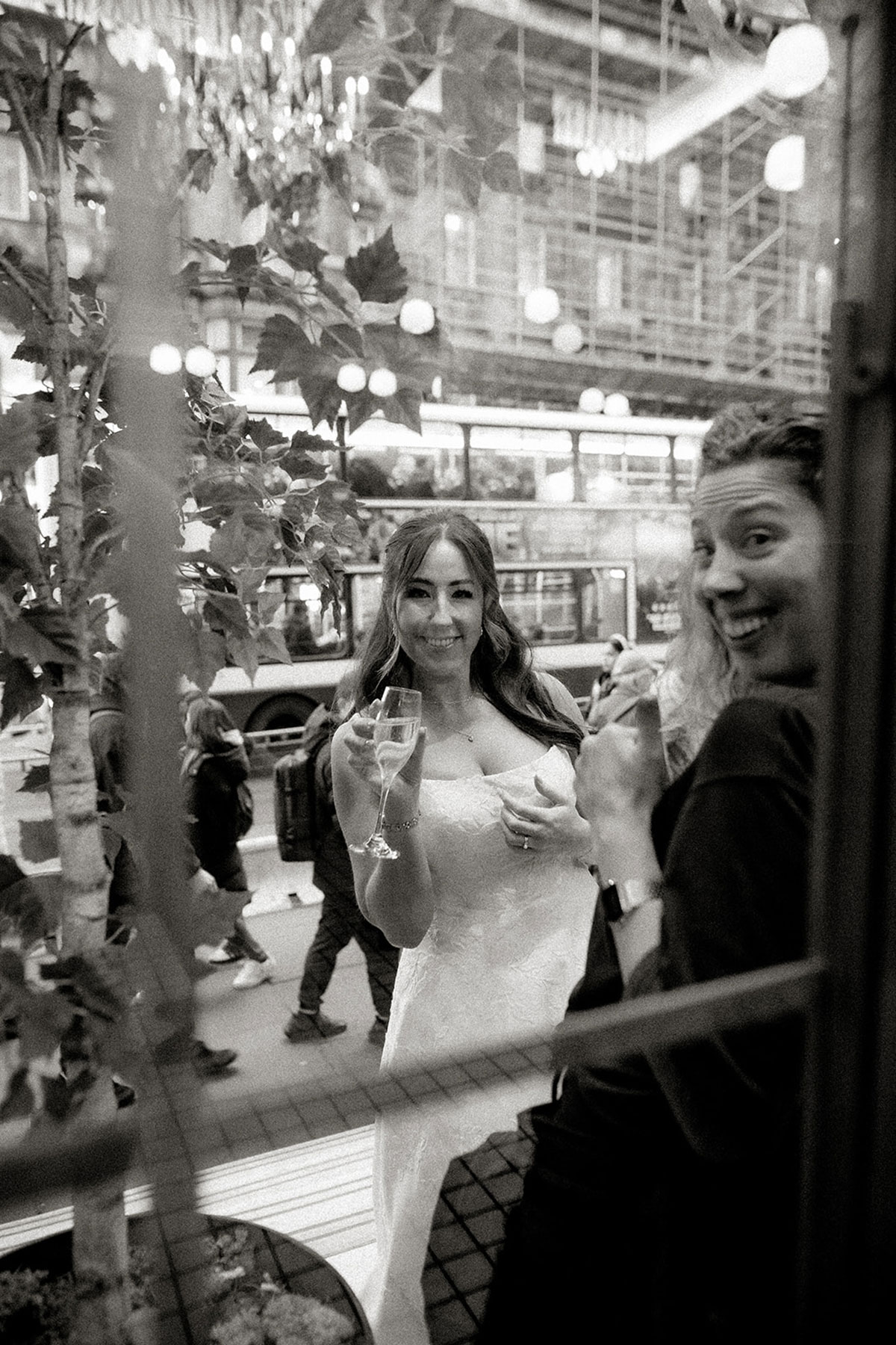 a candid photo of a smiling bride with a champagne flute