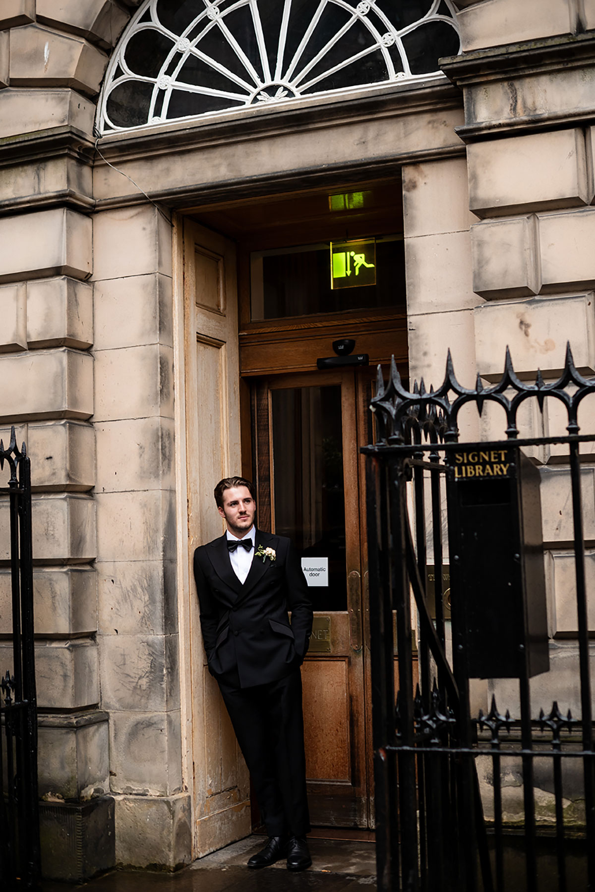 Groom portrait outside The Signet Library entrance in Edinburgh Old Town