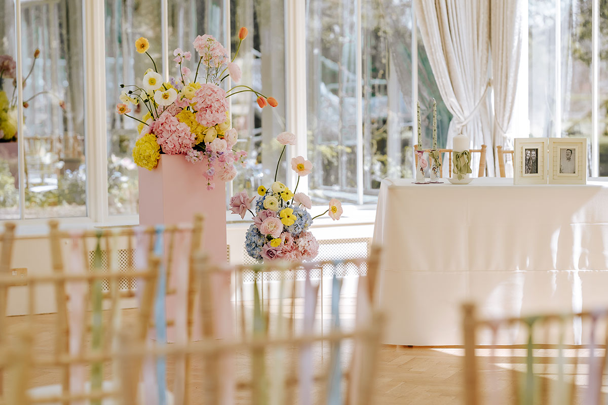 pastel wedding flowers and chairs for wedding ceremony at Carlowrie Castle