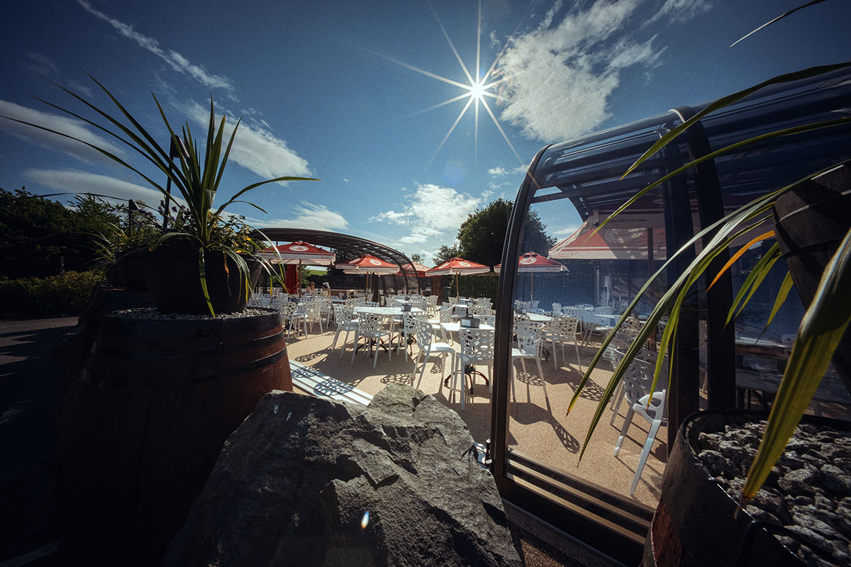 Riverside Glasshouse at The River Inn wedding venue in Renfrewshire with outdoor seating and retractable glass panels.