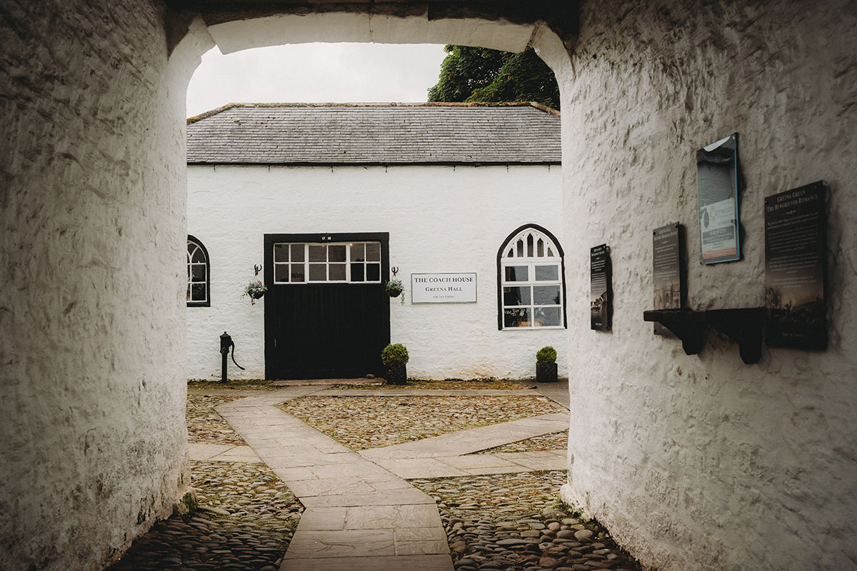Cobbled courtyard leading to the Coach House ceremony room at Gretna Hall wedding venue in Gretna Green