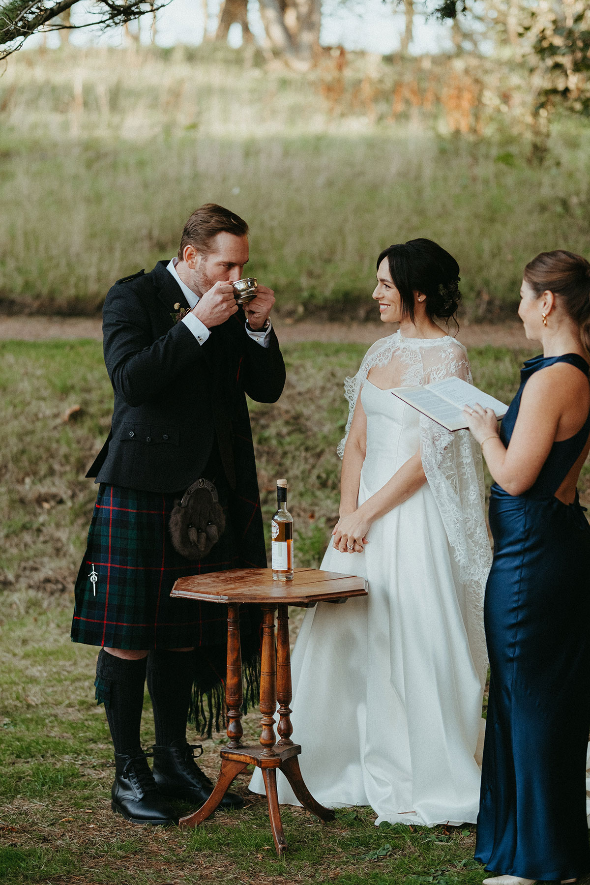 Bride and groom take part in a traditional quaich ceremony during their outdoor wedding at Cambo Country House in Fife.
