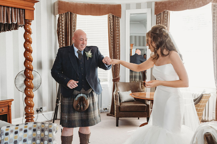Bride and dad fist bump during first look