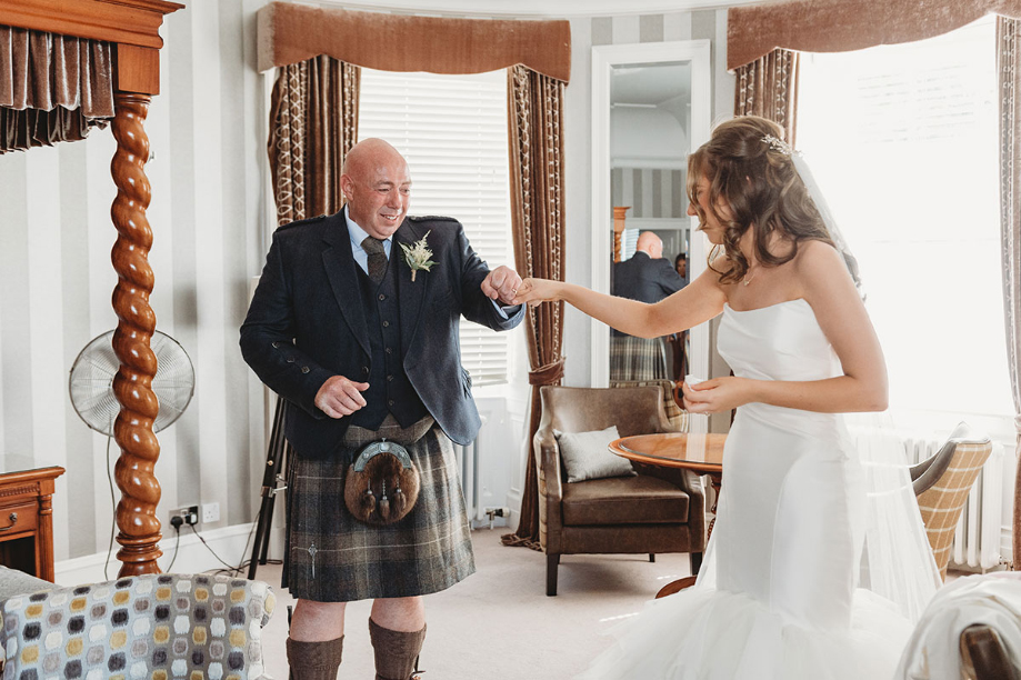 Bride and dad fist bump during first look