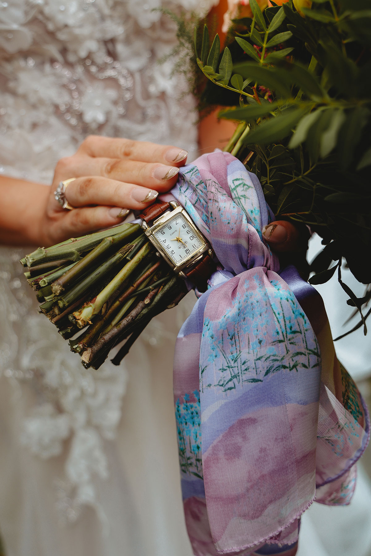 Close-up of a bride's bouquet tied with a personalised pastel ribbon and vintage watch at a Scottish wedding