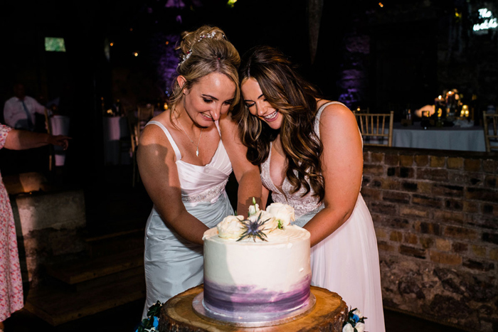 Two brides cut their cake