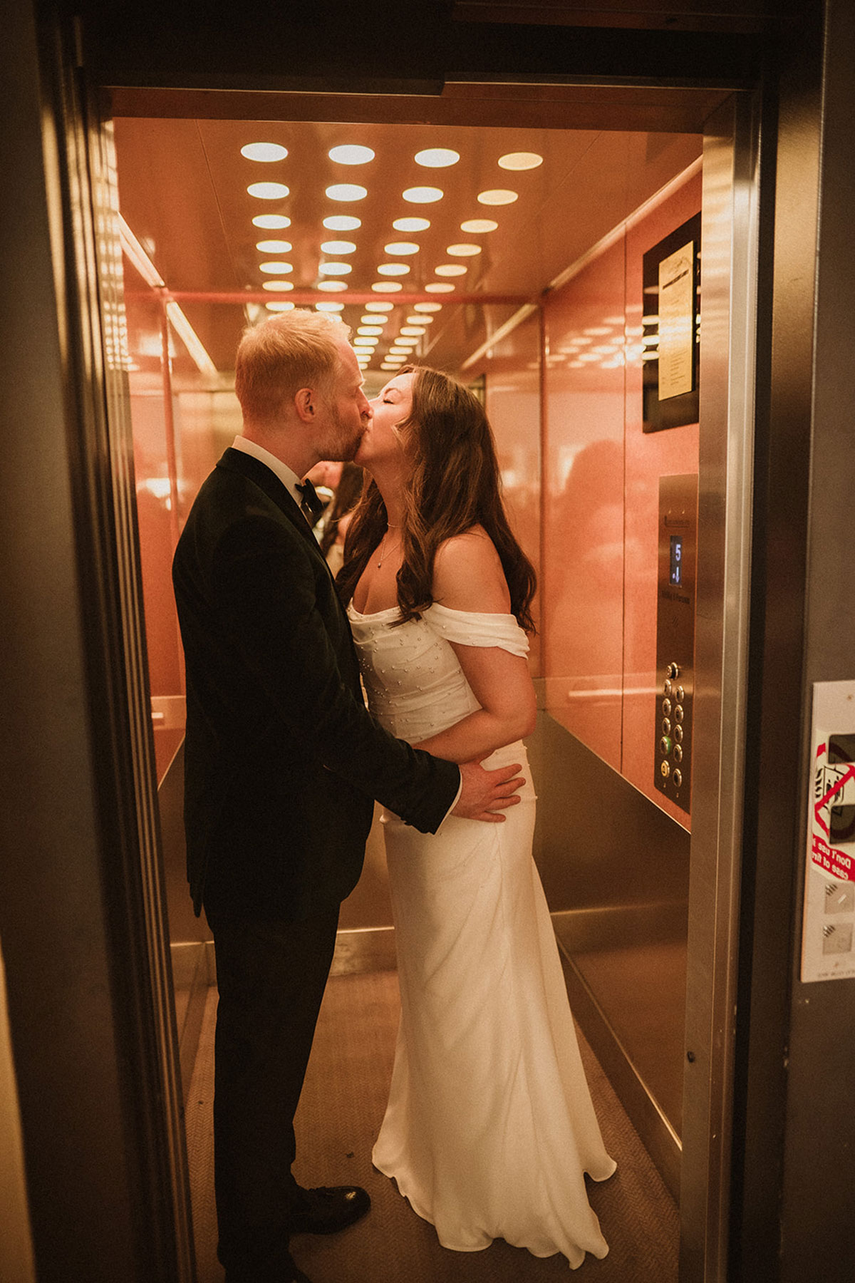a bride and groom kissing in an elevator at the Scotsman Hotel in Edinburgh