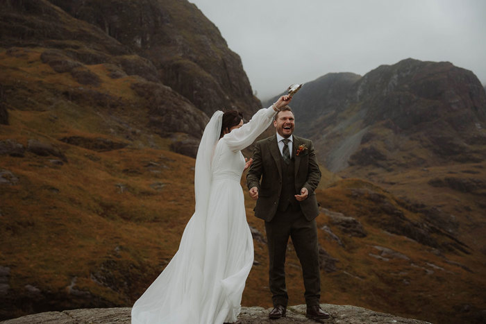 a bride and groom with a quaich during an outdoor mountain wedding ceremony in Glencoe
