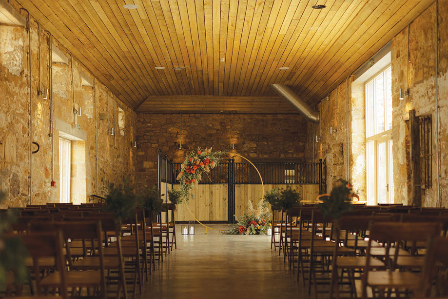 A barn with chair and an arch set up for a wedding