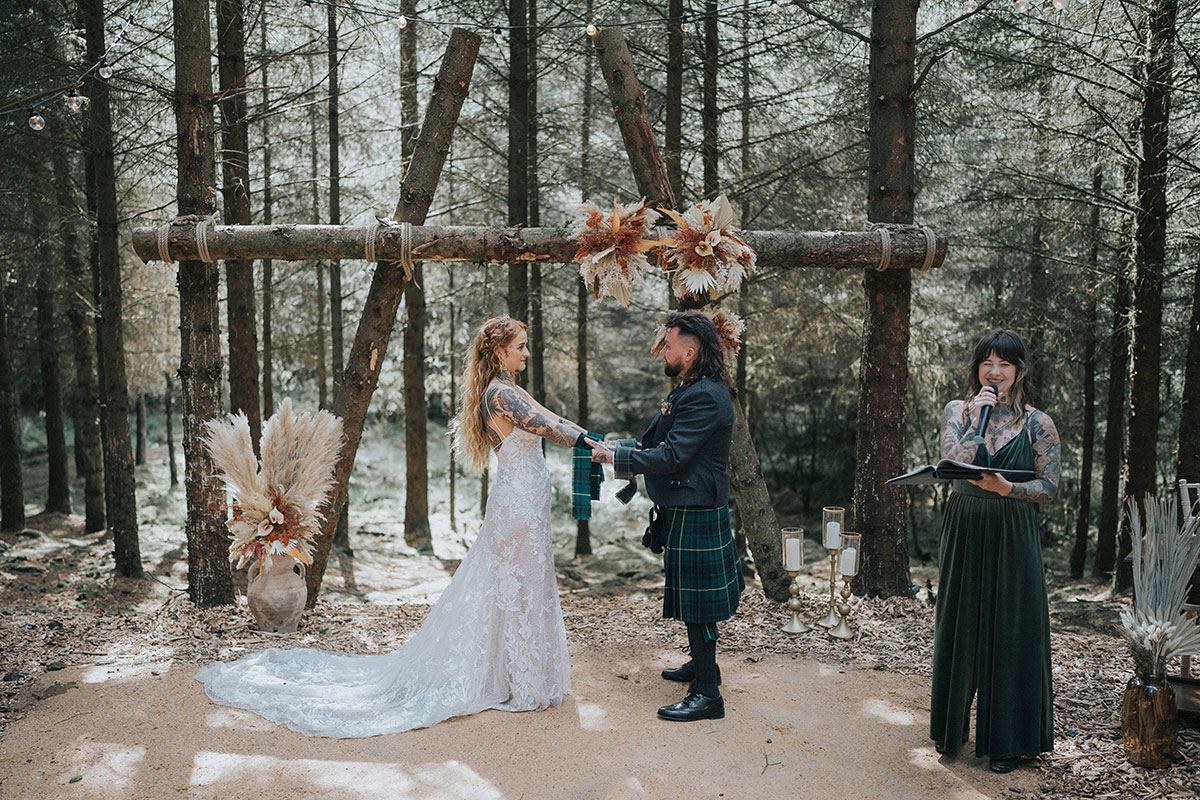 Couple getting married in a forest at Eden Leisure Village