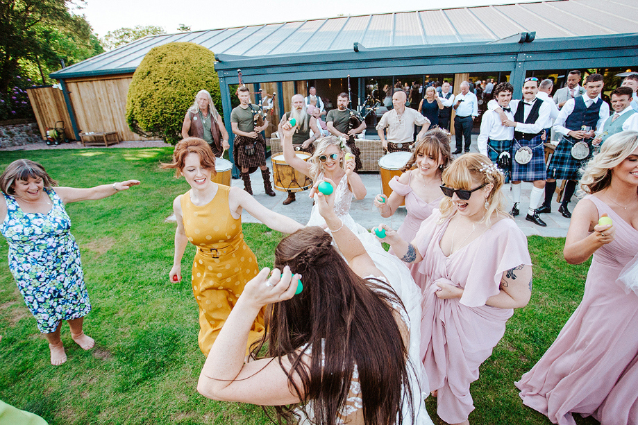Brides and guests dance outside