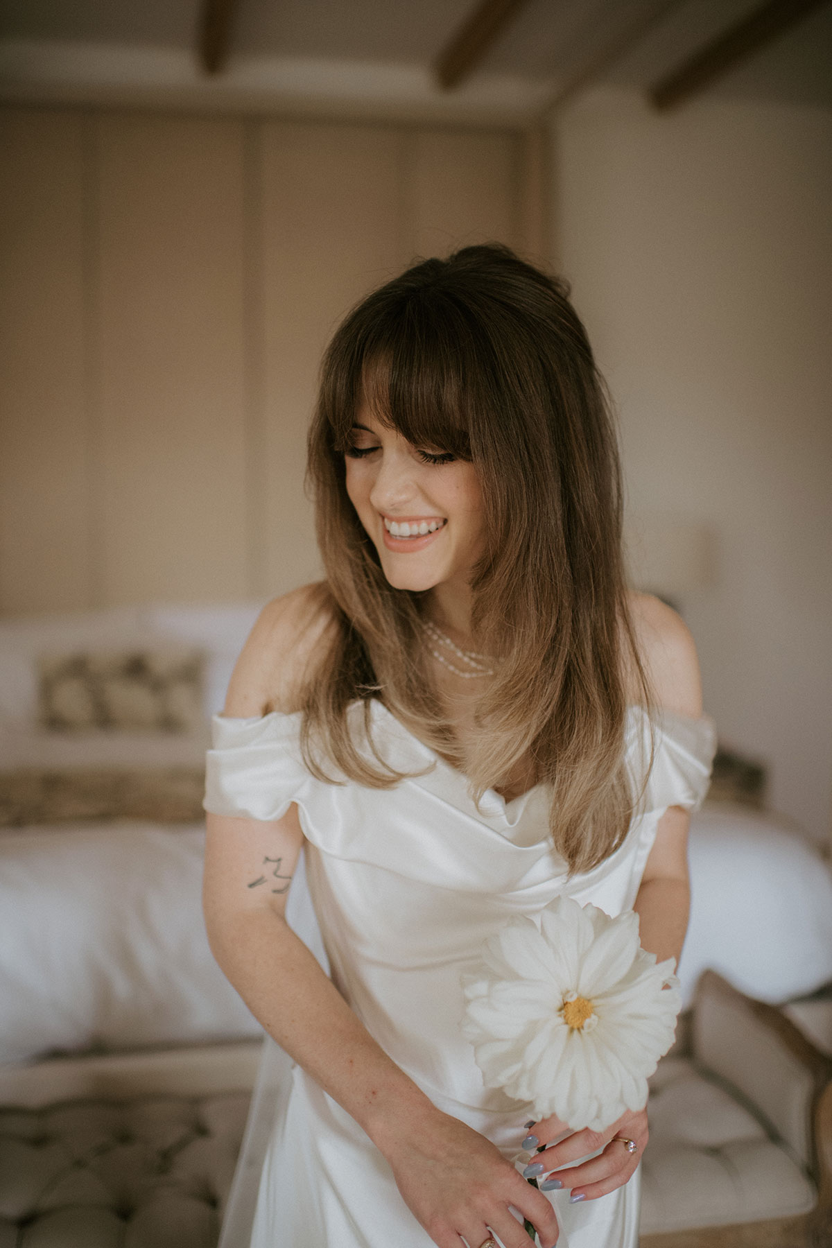 a smiling bride wearing a Vivienne Westwood wedding dress in a bedroom at Achnagairn Castle