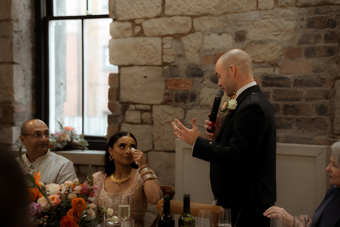 A Bride Crying As A Groom Looks At Her While Making A Wedding Speech at the Haberdashery