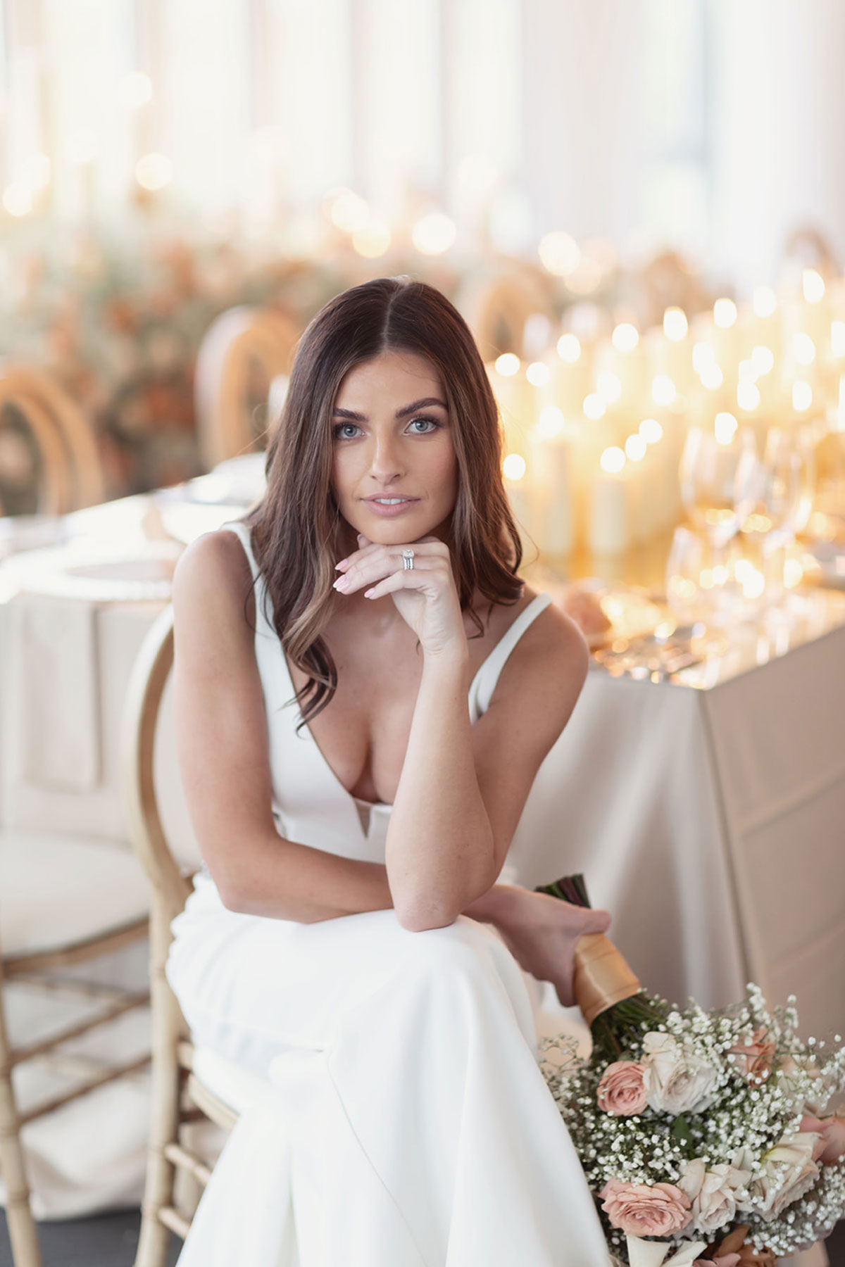 Bride seated portrait in Old Course Hotel Conservatory, St Andrews, surrounded by candlelit floral styling