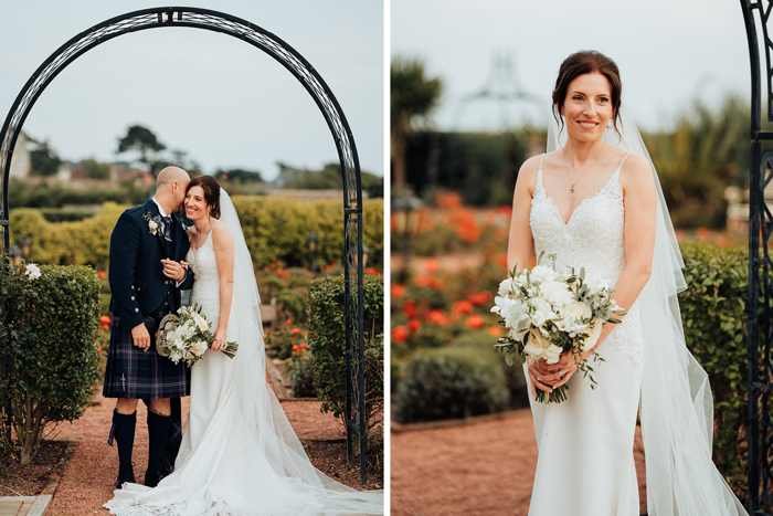 left image shows a smiling bride with groom whispering in her ear standing under a black ornamental arch amid a garden with green hedges, red flowers and orange stone gravel and right image shows a bride holding a white bouquet standing in a garden with green hedges and red flowers in background and orange gravel 