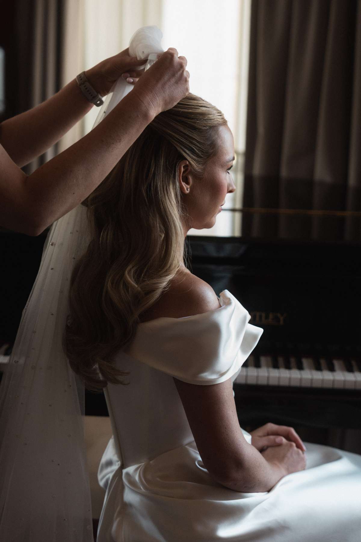 Bride Siân has her veil fitted over her half-up wedding hairstyle while getting ready for her Mar Hall wedding.