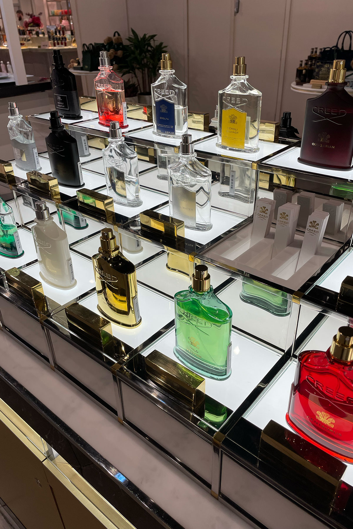 Creed fragrance bottles displayed on illuminated mirrored stands at H beauty Silverburn.