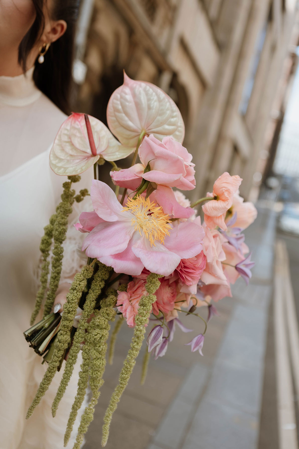 Pink bridal bouquet with roses, anthuriums and soft pastel wedding flowers