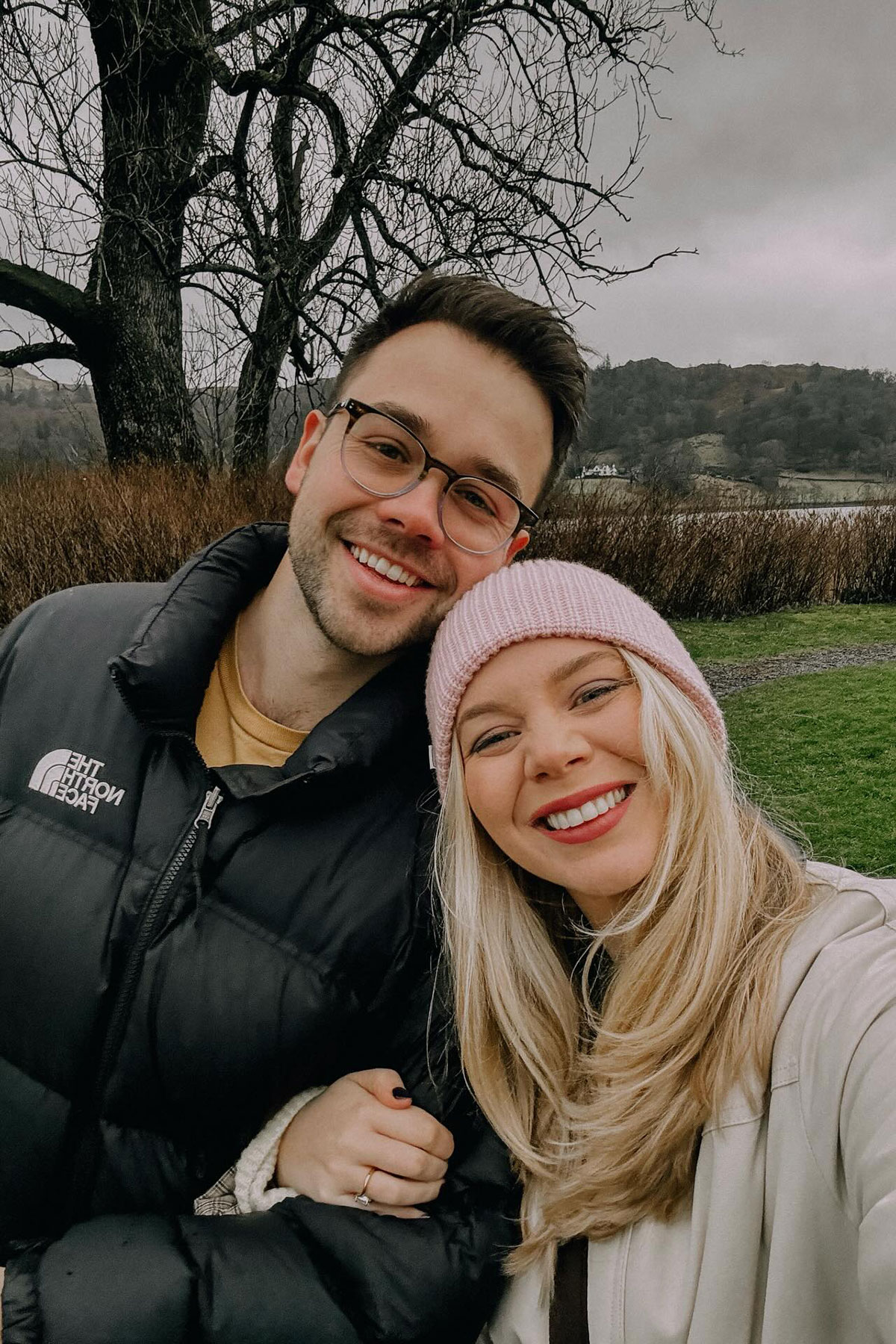 Happy engaged couple posing for a countryside selfie during a winter walk in Scotland