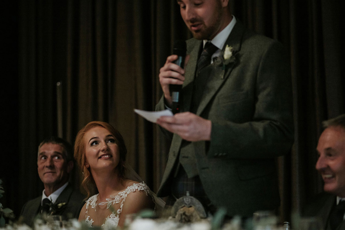 A Bride Watching On As Groom Does Wedding Speech