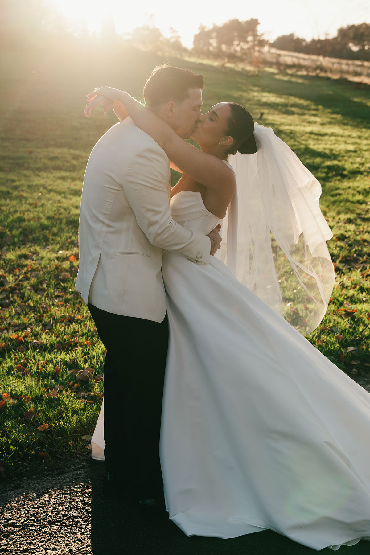 Romantic sunset wedding portrait of bride and groom kissing at Enterkine Country House Resort Ayrshire