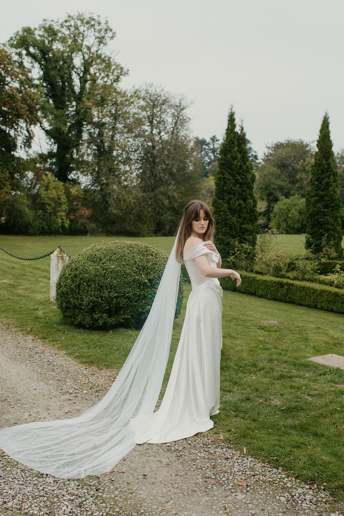 a bride wearing a Vivienne Westwood dress in the garden at Achnagairn Castle