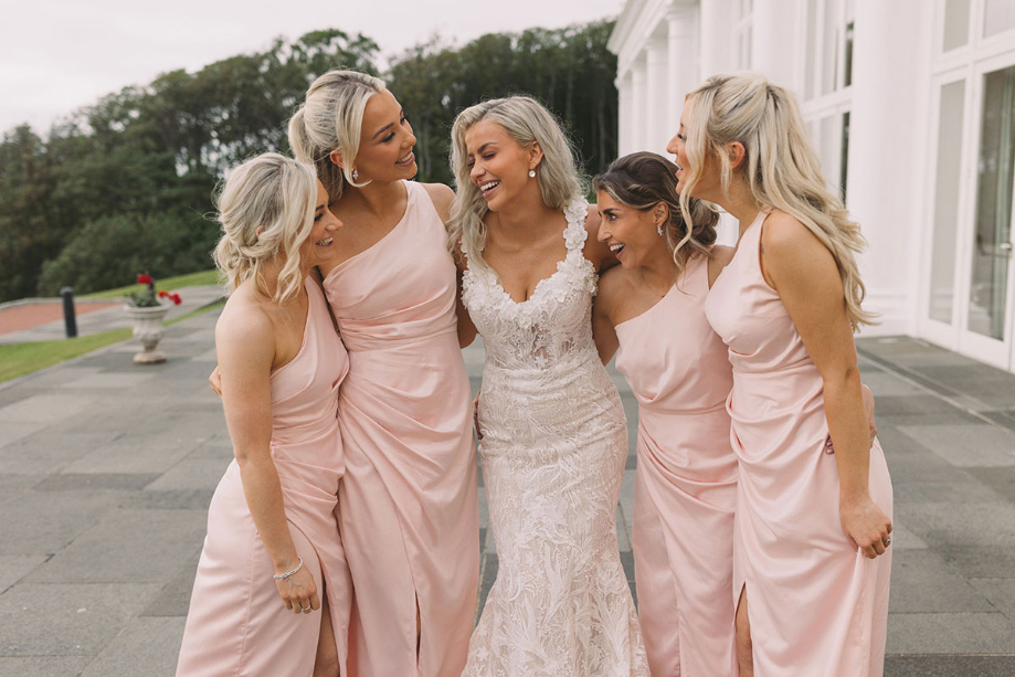 Bride with four bridesmaids wearing pink dresses