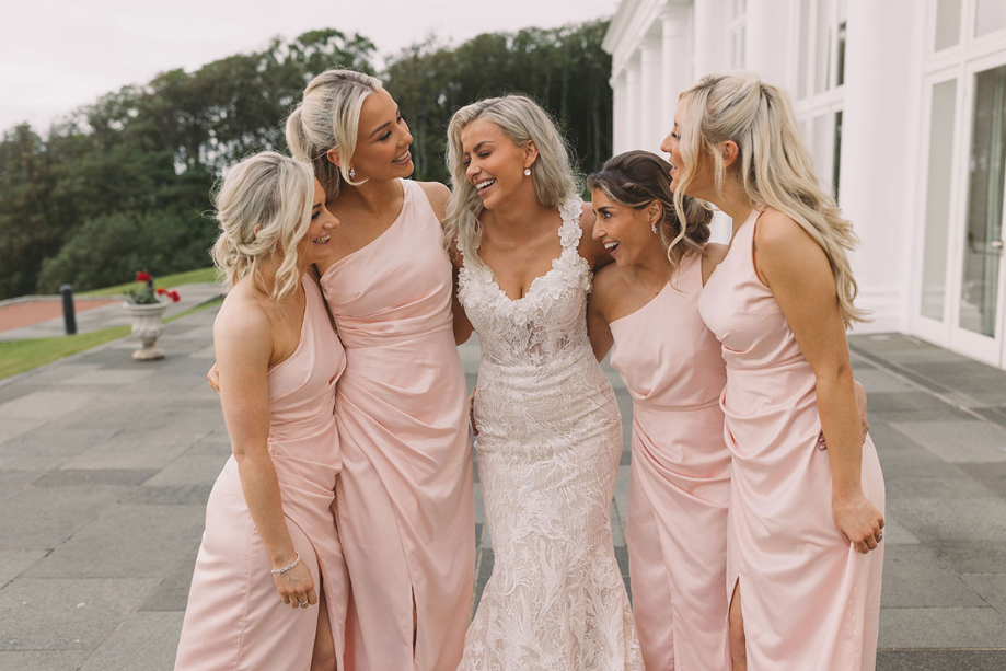 Bride with four bridesmaids wearing pink dresses