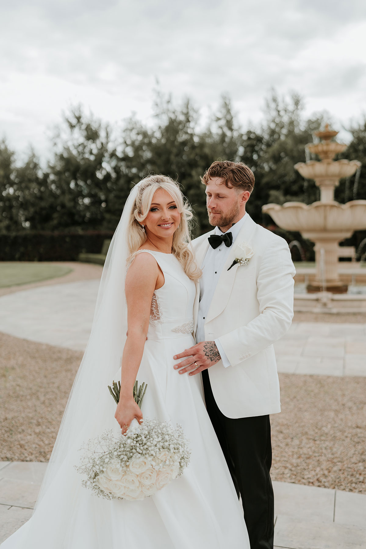 Bride and groom portrait by fountain at Ingliston Country Club wedding venue in Renfrewshire