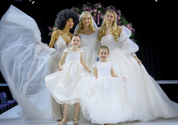 a group of women in ivory dresses on the catwalk at the Scottish Wedding Show