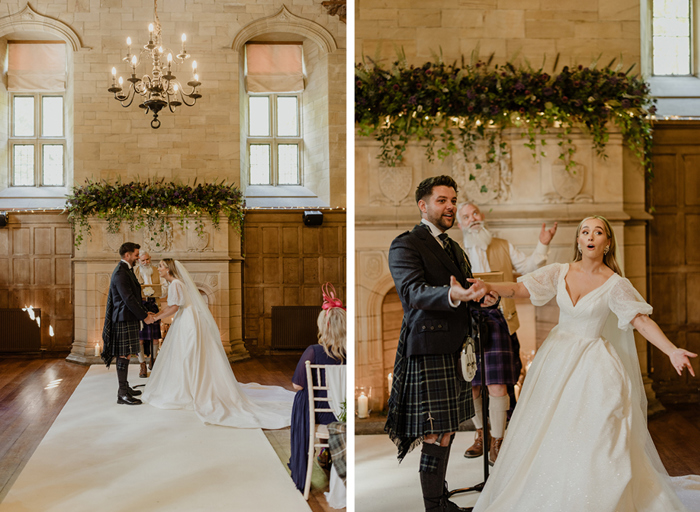 a bride and groom gesture animatedly and laugh as they stand against a large stone fireplace decked with greenery during their wedding ceremony at Achngairn Castle. The officiant stands in the background gesturing and reading
