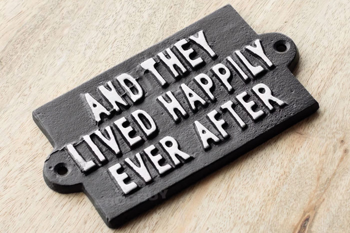 an black iron sign that reads 'And they lived happily ever after'