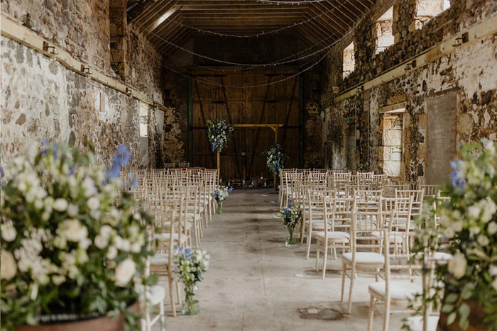 a wedding ceremony set up in a barn