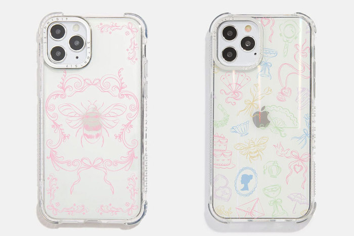 Two clear phone cases on white iPhones, the one on the left has a bee and bows in pink and the one on the left has different symbols in different colours