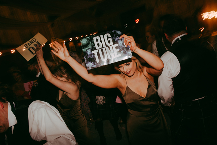 Guest holds up 'big tune' sign during the DJ battle