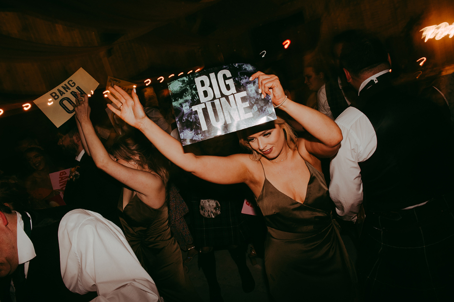 Guest holds up 'big tune' sign during the DJ battle