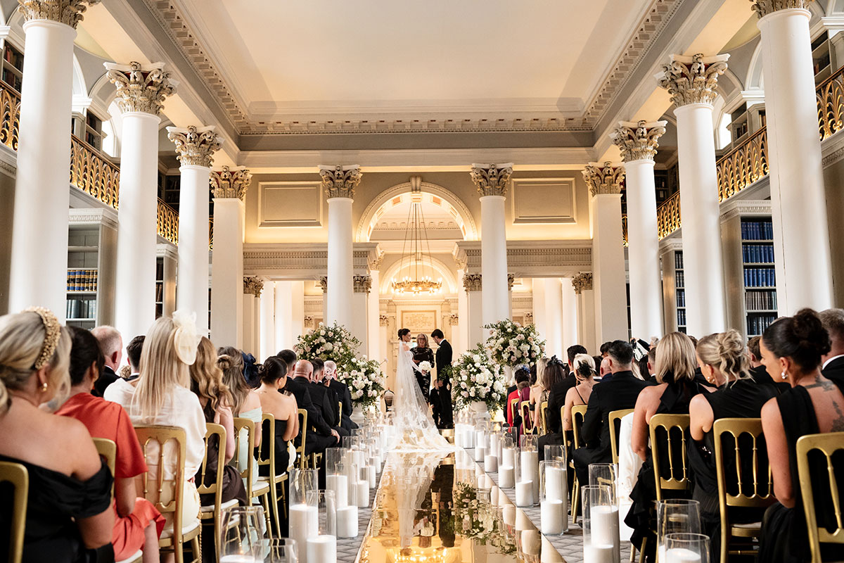 Wedding ceremony setup at The Signet Library Edinburgh with mirrored aisle and candles