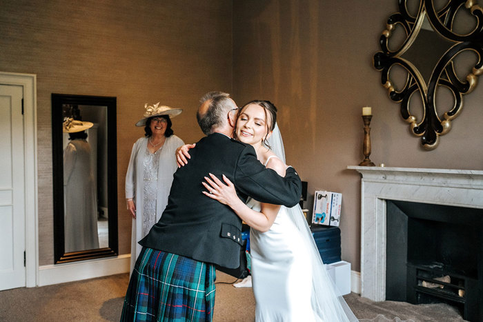 bride hugs dad wearing a kilt at mar hall