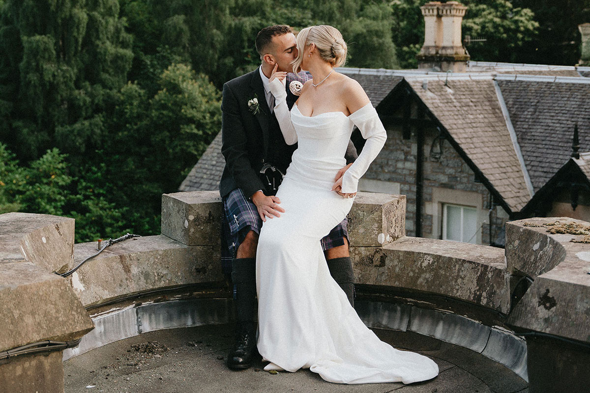 bride and groom kissing on wedding day at atholl palace hotel