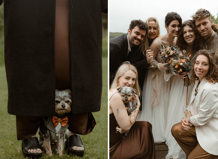 a small terrier dog standing on grass taking shelter in the fold of a person's long skirt on left. People posing for a photo at a wedding with a small dog on right