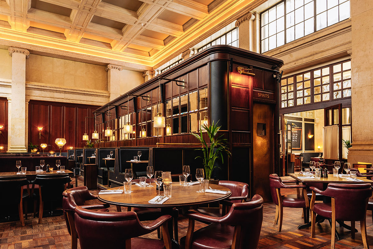 Hawksmoor Edinburgh restaurant interior with dark wood panelling, leather seating and original banking hall architecture.
