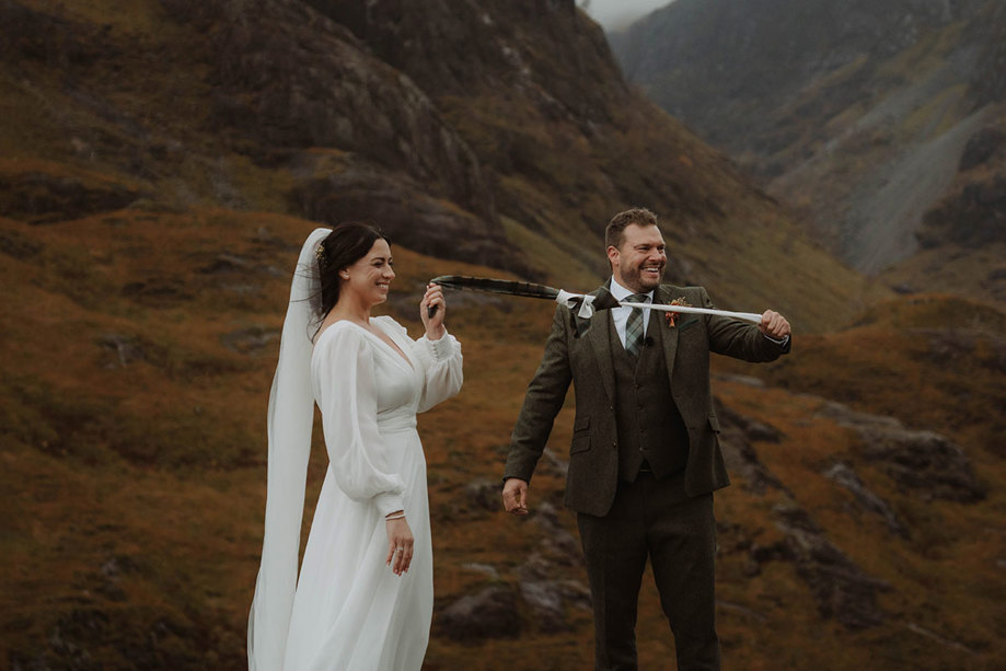 a bride and groom hand fasting during a Glencoe outdoor wedding ceremony
